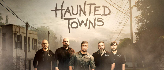 A group of men standing in front of a building featured on paranormal shows on TV, with the words haunted towns.