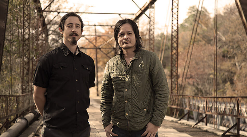 Two youtube ghost hunters called Strange Town standing next to each other on a bridge.